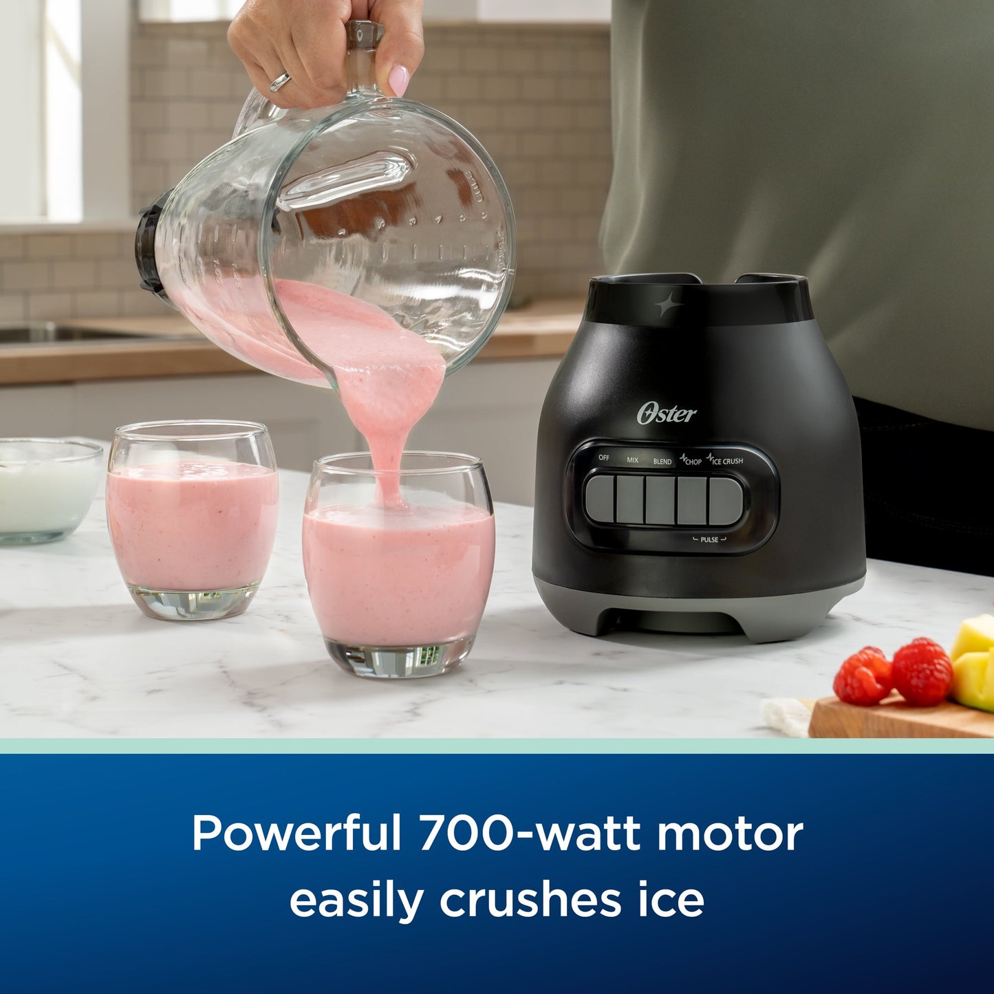 Person pouring pink smoothie into glasses next to a Oster blender.