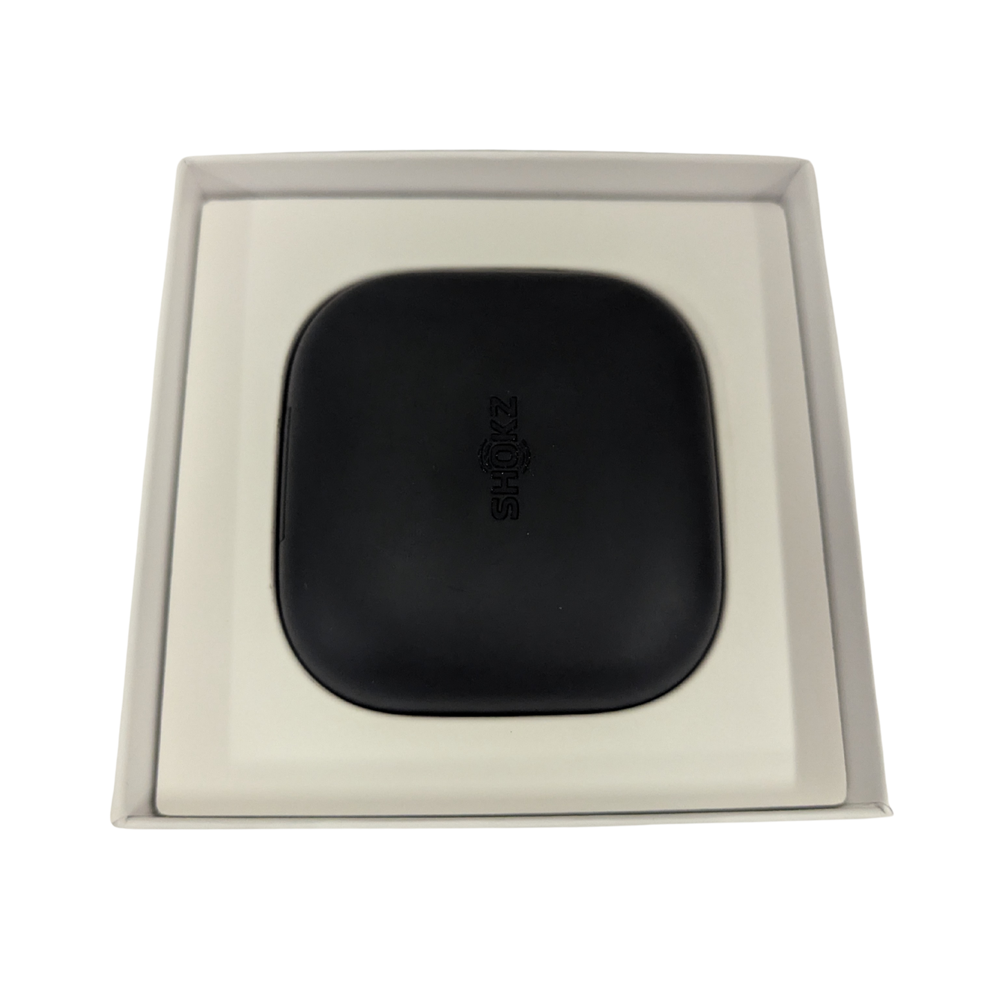Black square object with 'Bose' branding in a beige box on a white background