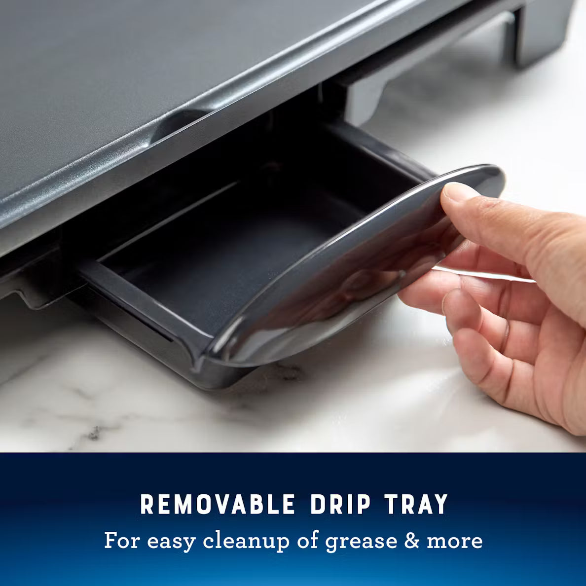 Hand opening a removable drip tray on a kitchen appliance with text 'Removable Drip Tray for easy cleanup of grease & more'.