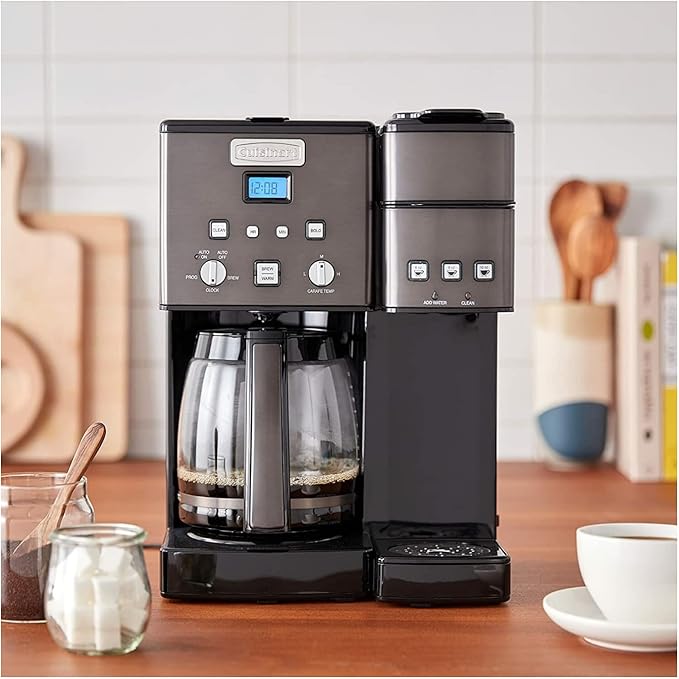Black coffee maker on a wooden countertop with a blurred kitchen background
