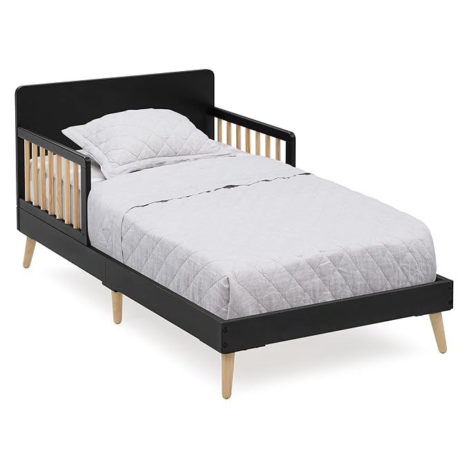 Black and wood children's bed with white bedding on a white background