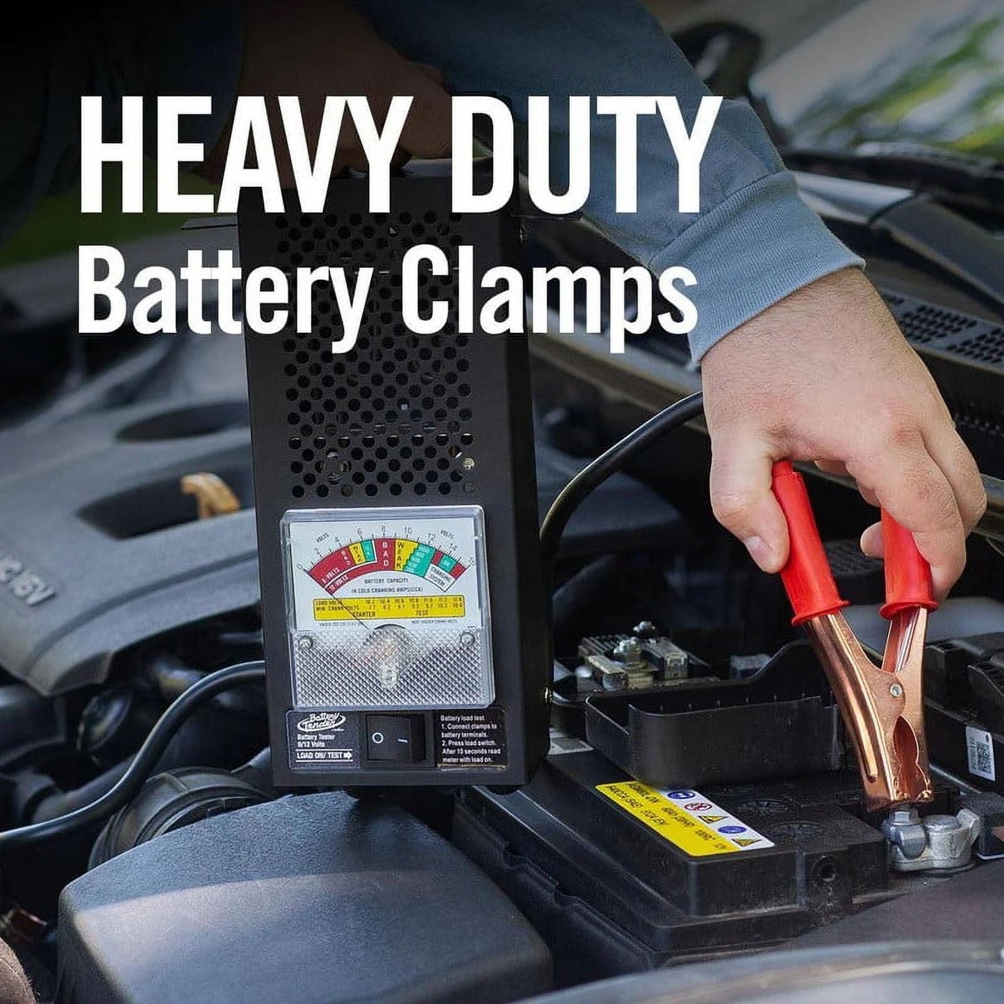 Person using heavy-duty battery clamps on a car battery with text 'HEAVY DUTY Battery Clamps'.