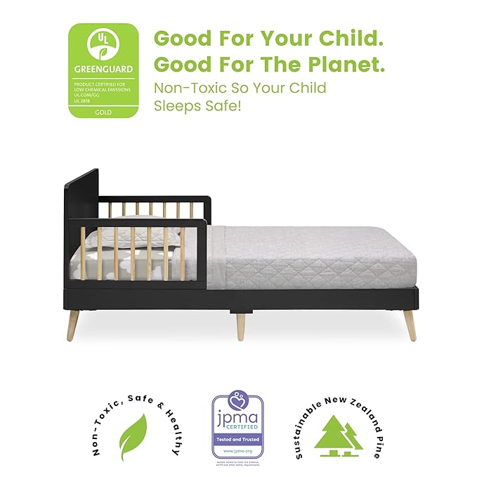 Children's bed with mattress and Greenguard Gold certification label on a white background