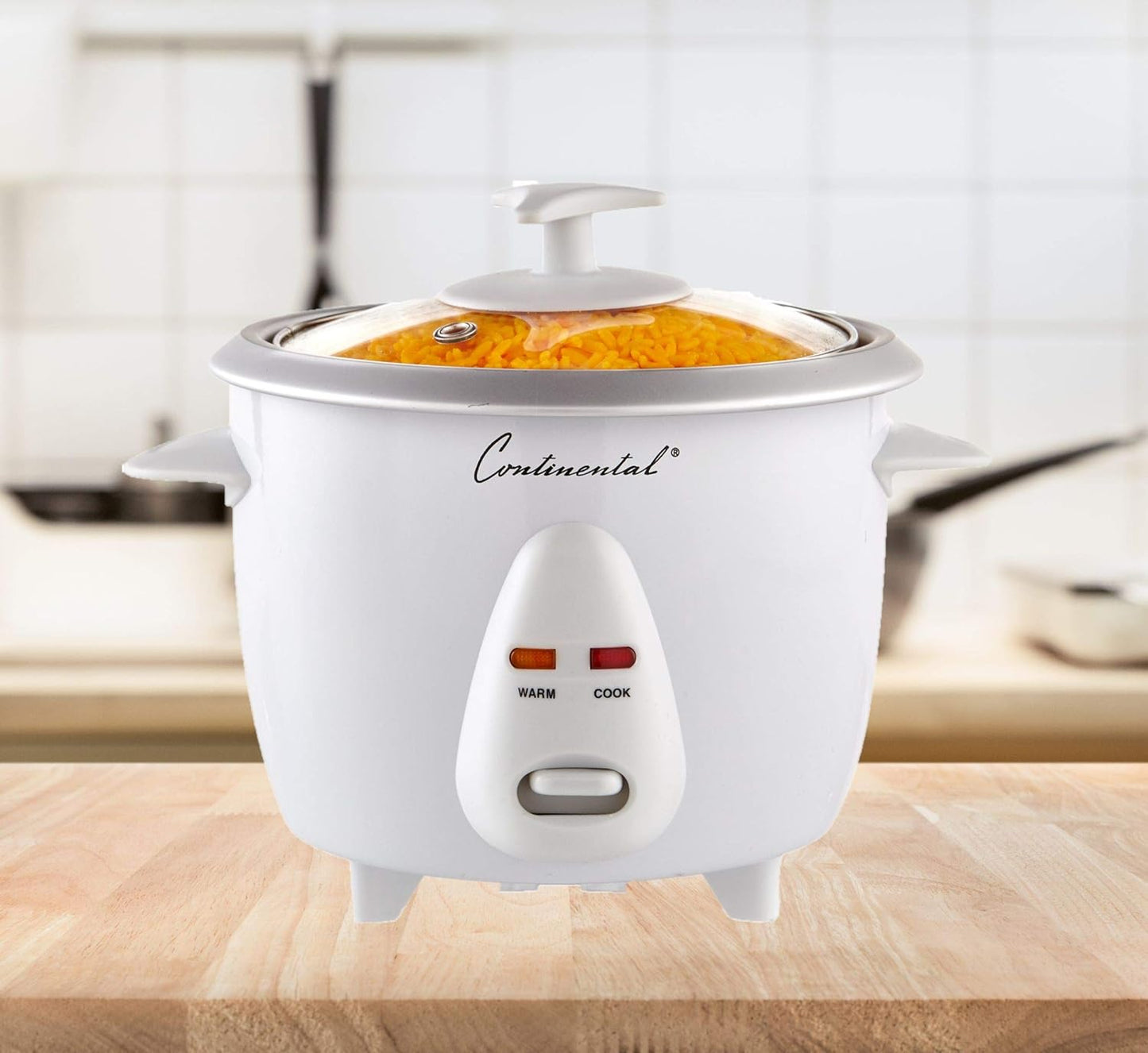 White rice cooker with 'Continental' branding on a wooden surface.