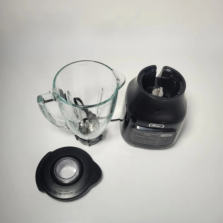 Blender components including a clear pitcher, black base, and lid on a light gray background