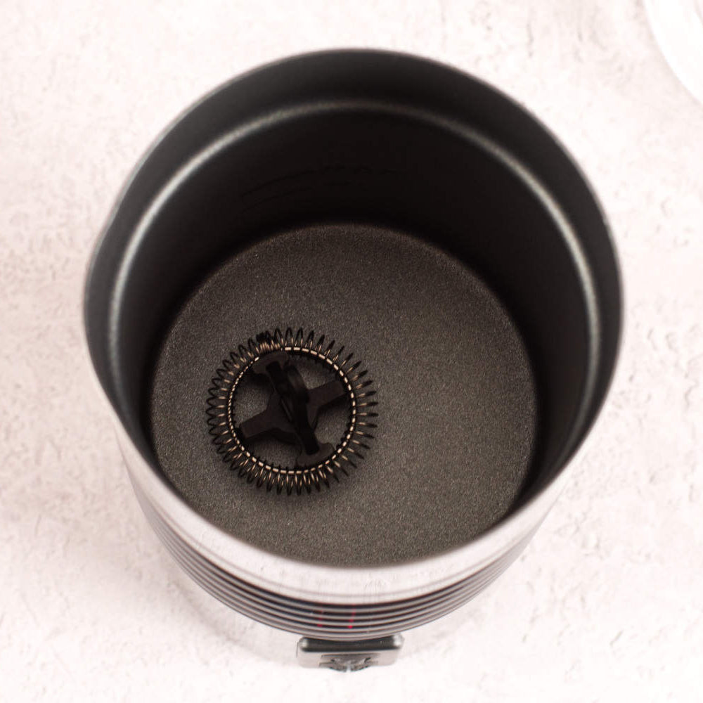 Close-up of a metal component with gears on a white background