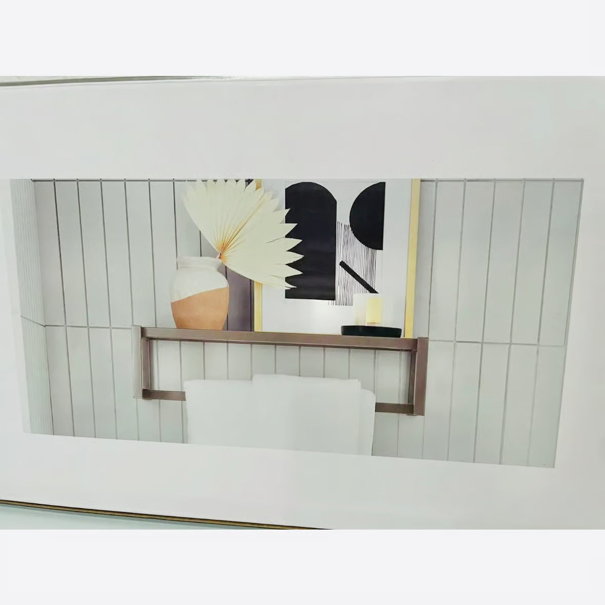 Decorative shelf with a vase and abstract art against a wooden panel wall.