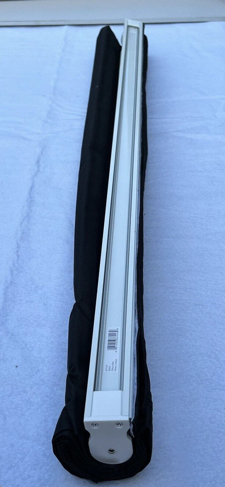 Fluorescent light bulb in a black holder on a white background