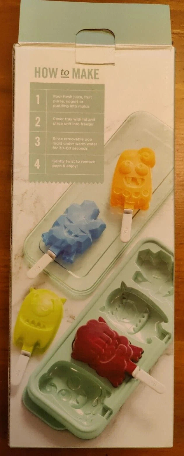 Popsicle mold with colorful popsicles on a wooden surface