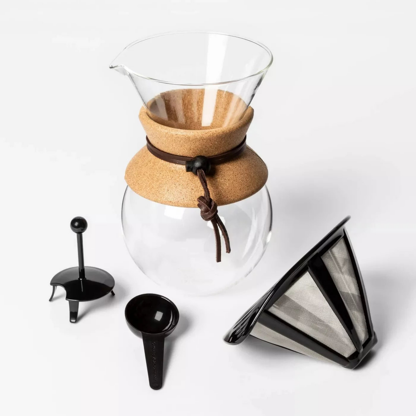 Clear glass coffee maker with cork lid and accessories on a white background
