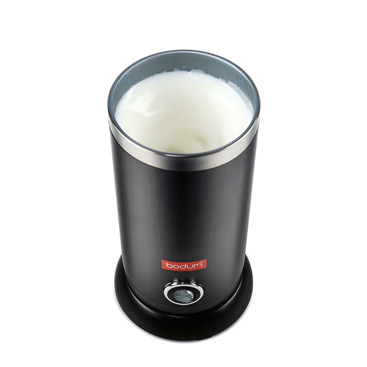 Black Bodum milk frother with frothed milk on a white background