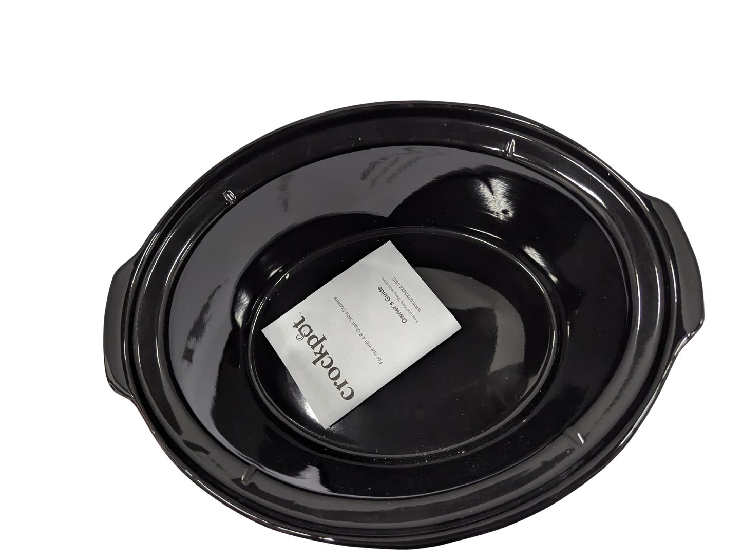 Black crock pot with a white label on a white background