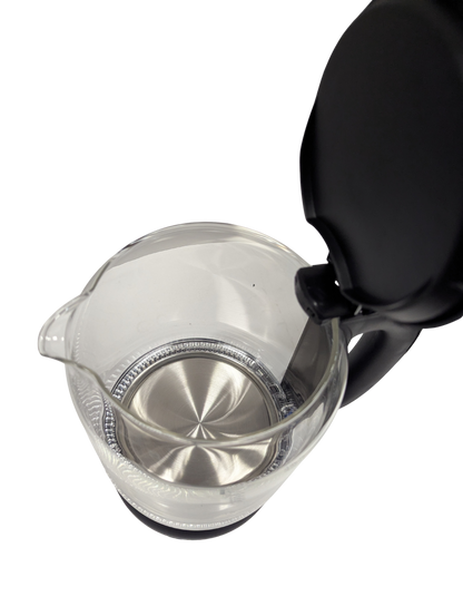 Clear glass teapot with black lid on a white background