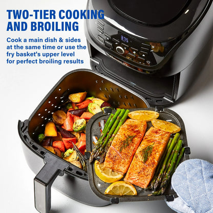 Air fryer with salmon, vegetables, and lemon wedges inside, showing two-tier cooking and broiling capabilities.