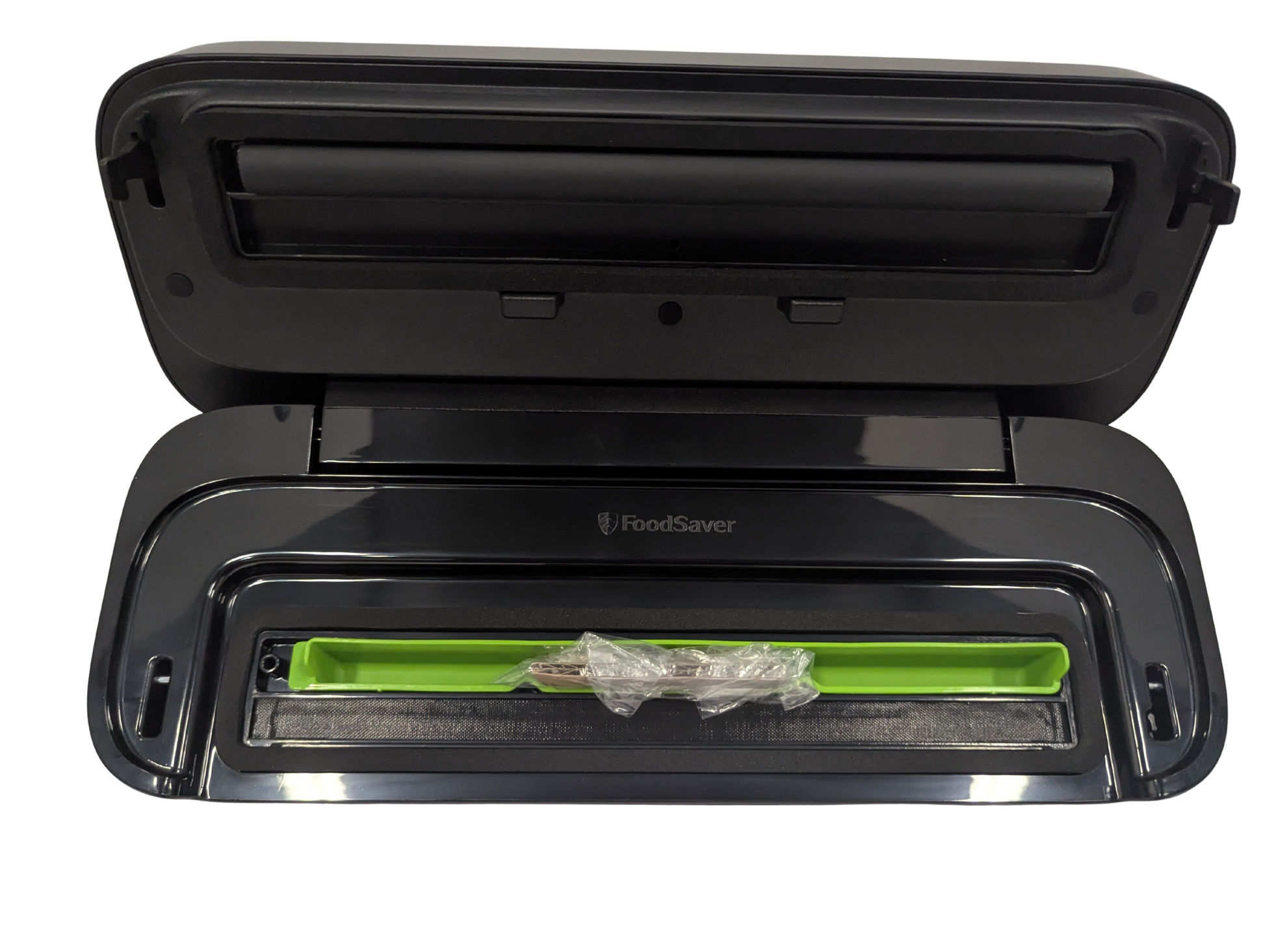 Black FoodSaver vacuum sealer with a green sealing bar on a white background
