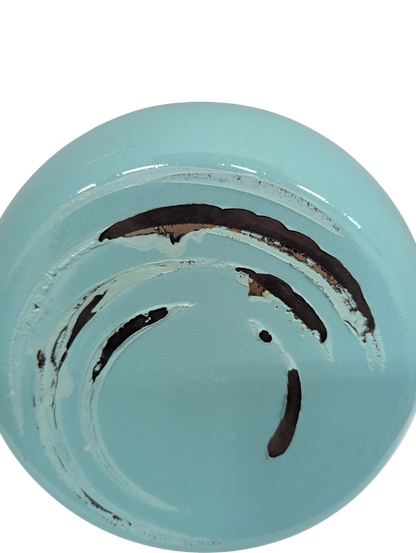 Light blue ceramic plate with black abstract design on a white background