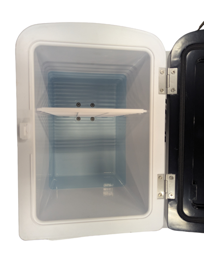 White freezer with open door on a white background