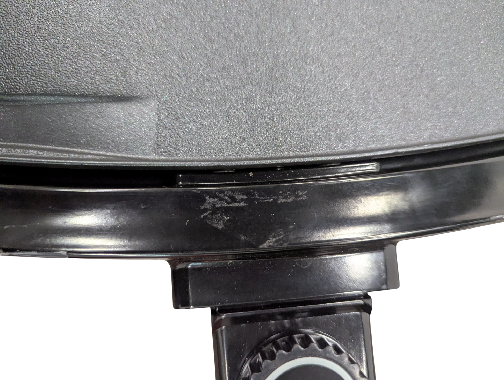 Close-up of a pressure cooker lid with a brand logo on a white background