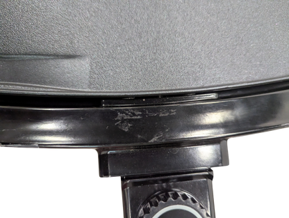 Close-up of a pressure cooker lid with a brand logo on a white background