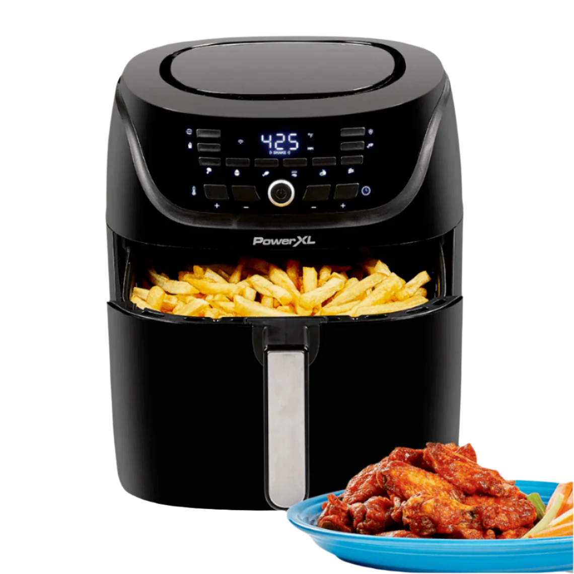 Black PowerXL air fryer with fries and a plate of wings on a white background