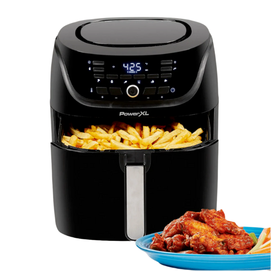 Black PowerXL air fryer with fries and a plate of wings on a white background