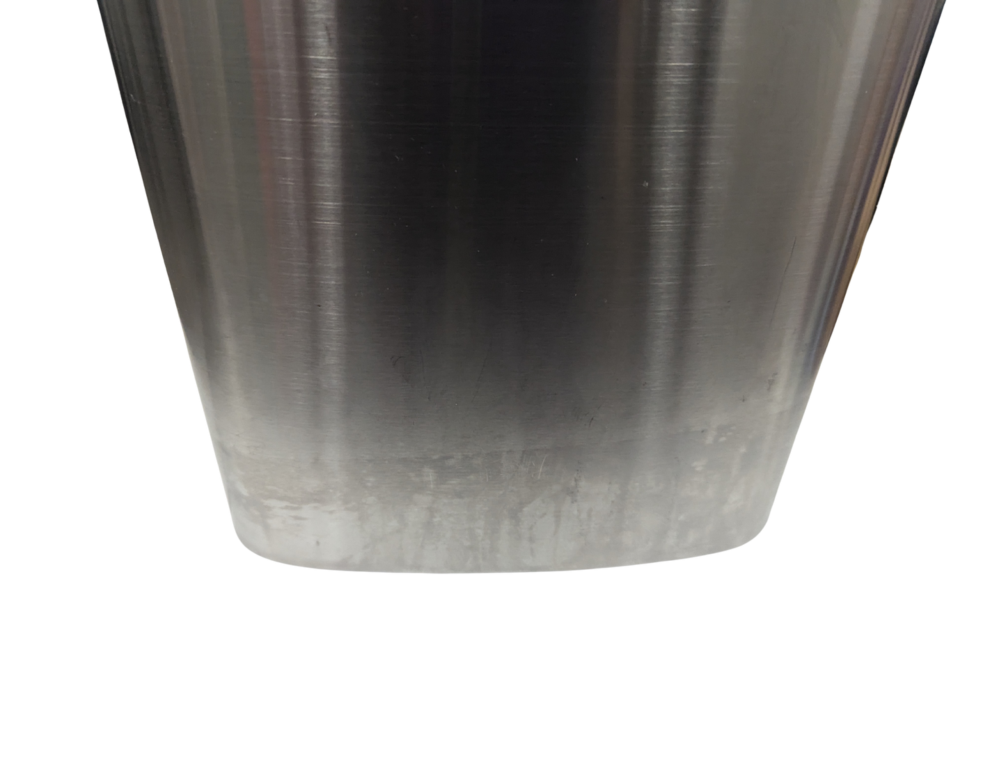Close-up of a metallic object with a gradient finish on a white background