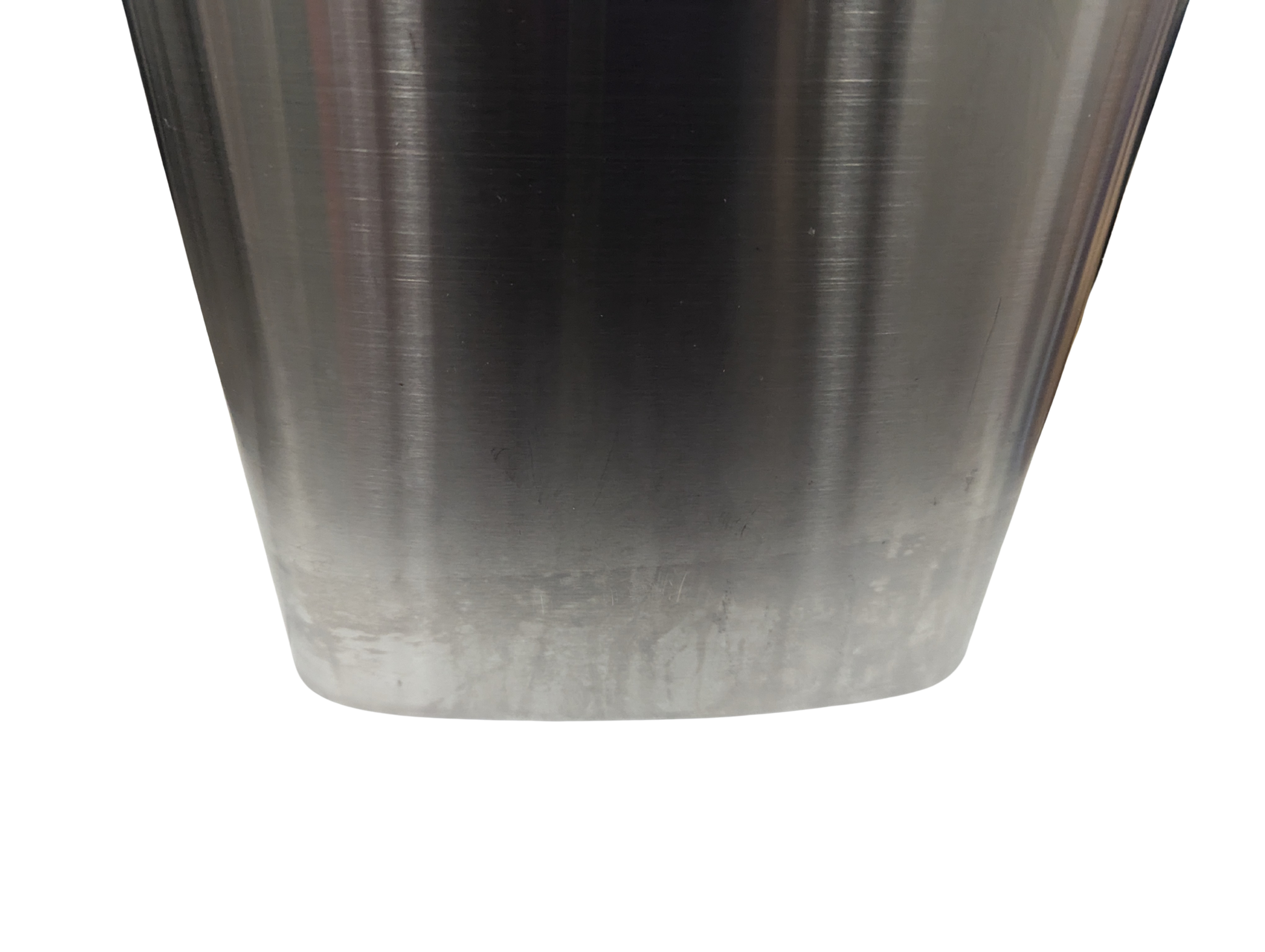 Close-up of a metallic object with a gradient finish on a white background