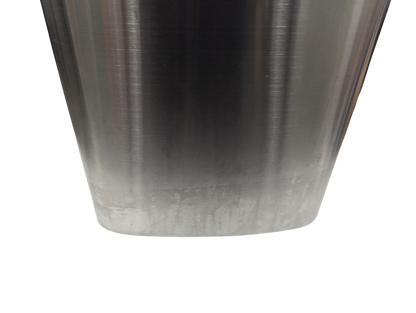 Close-up of a metallic object with a gradient finish on a white background