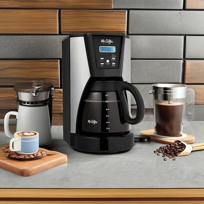 Black coffee maker on a kitchen counter with coffee cups, beans, and a tiled wall background.
