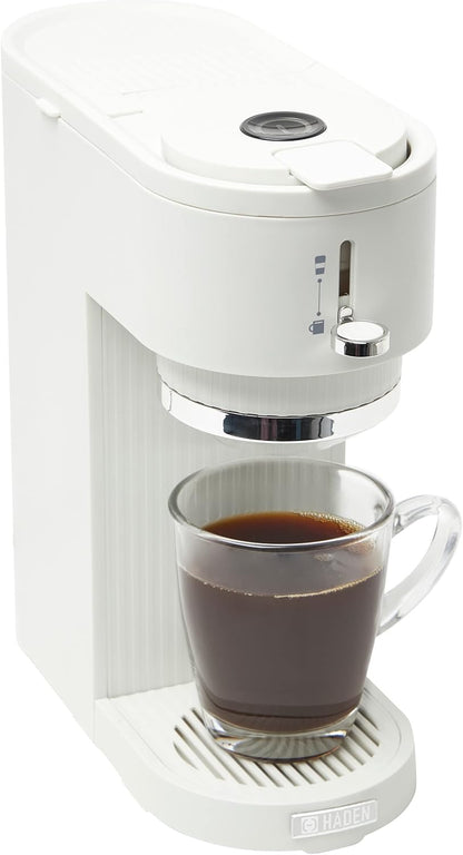 White coffee machine dispensing a cup of coffee