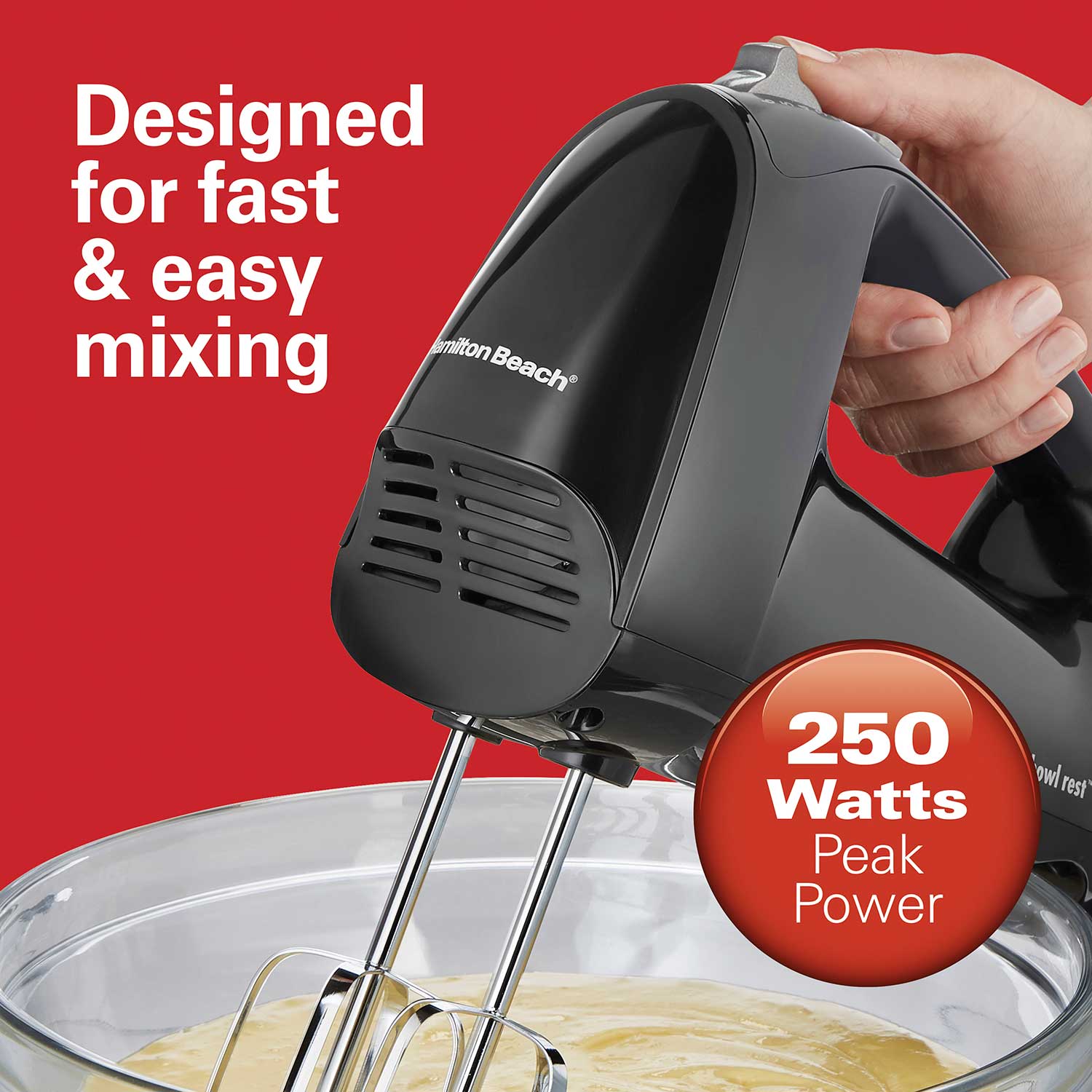 Hand mixer with 'Hamilton Beach' branding being used to mix ingredients in a bowl, against a red background.