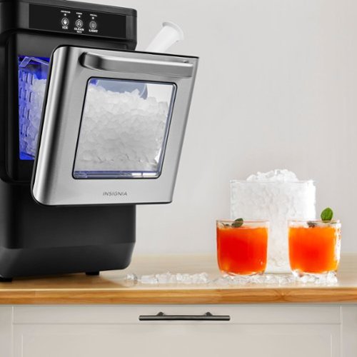 Ice maker with two glasses of red drinks on a countertop