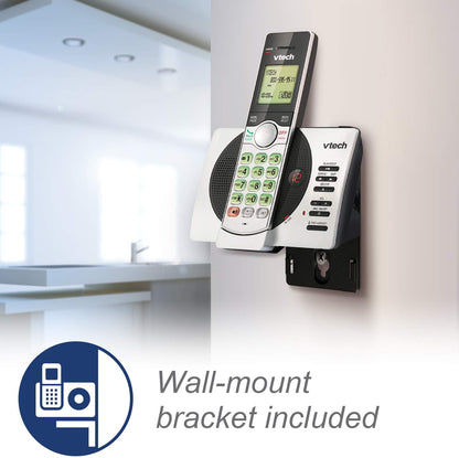 Vtech cordless phone with wall mount bracket on a white wall.