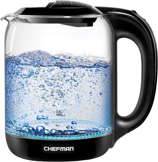 Glass electric kettle with black handle and base, filled with water, on a white background.
