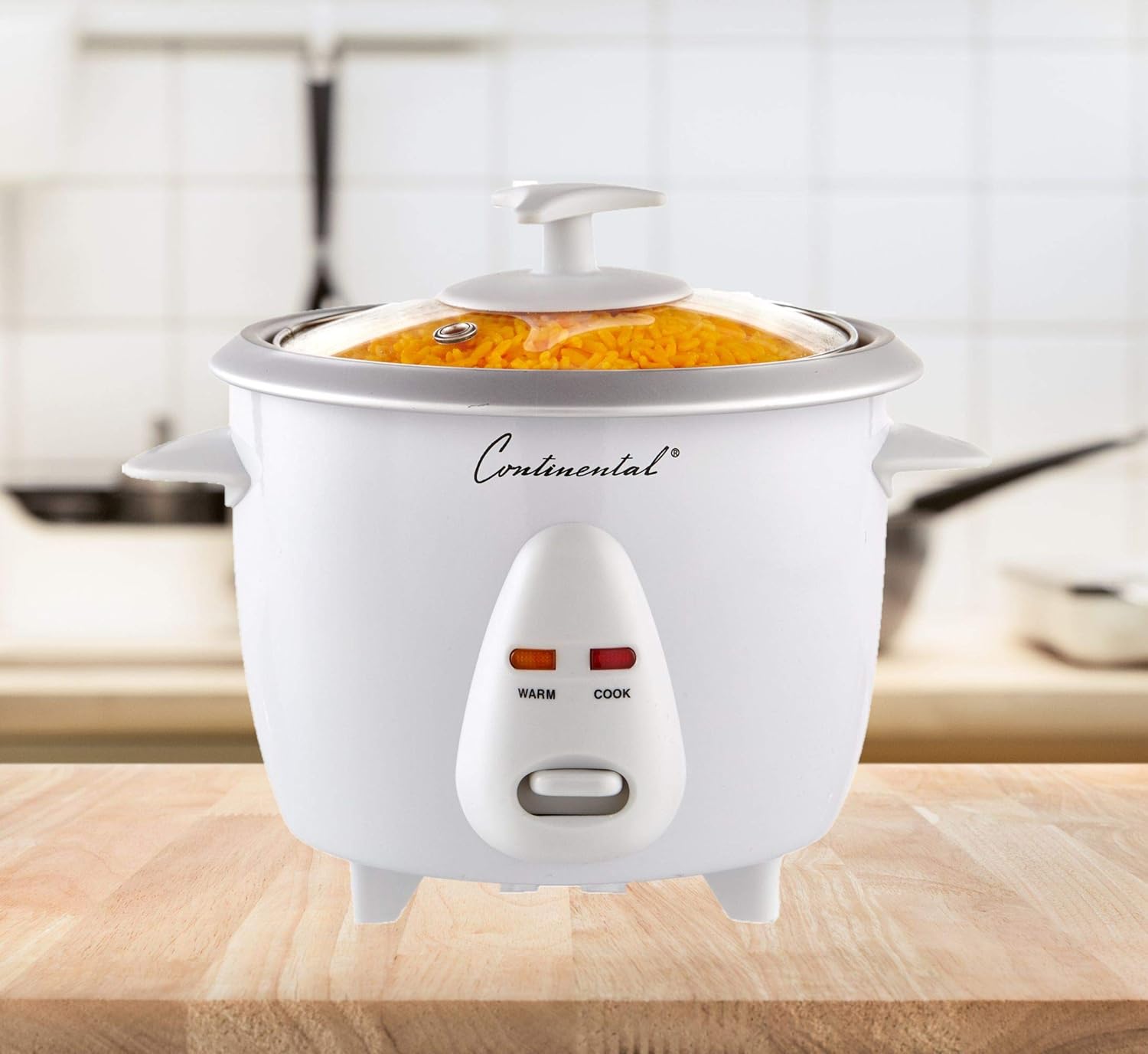 White rice cooker with 'Continental' branding on a wooden surface.