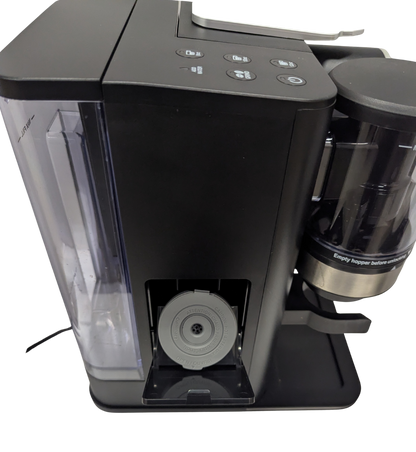 Black coffee machine with transparent water tank on a white background