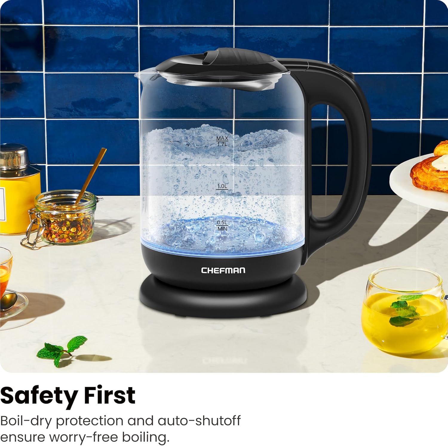 Chefman electric kettle on a kitchen counter with safety features highlighted.