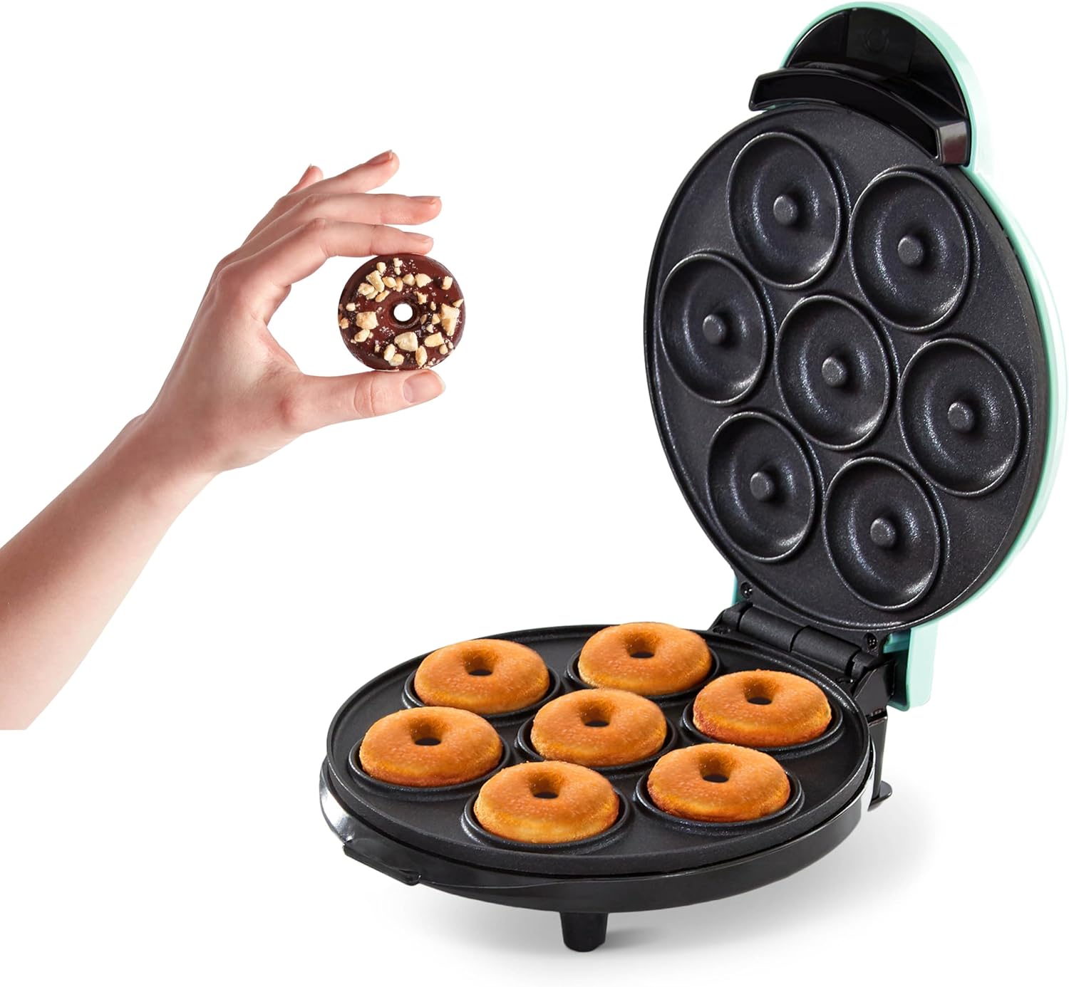 Donut maker with freshly made donuts and a hand holding a donut above it on a white background