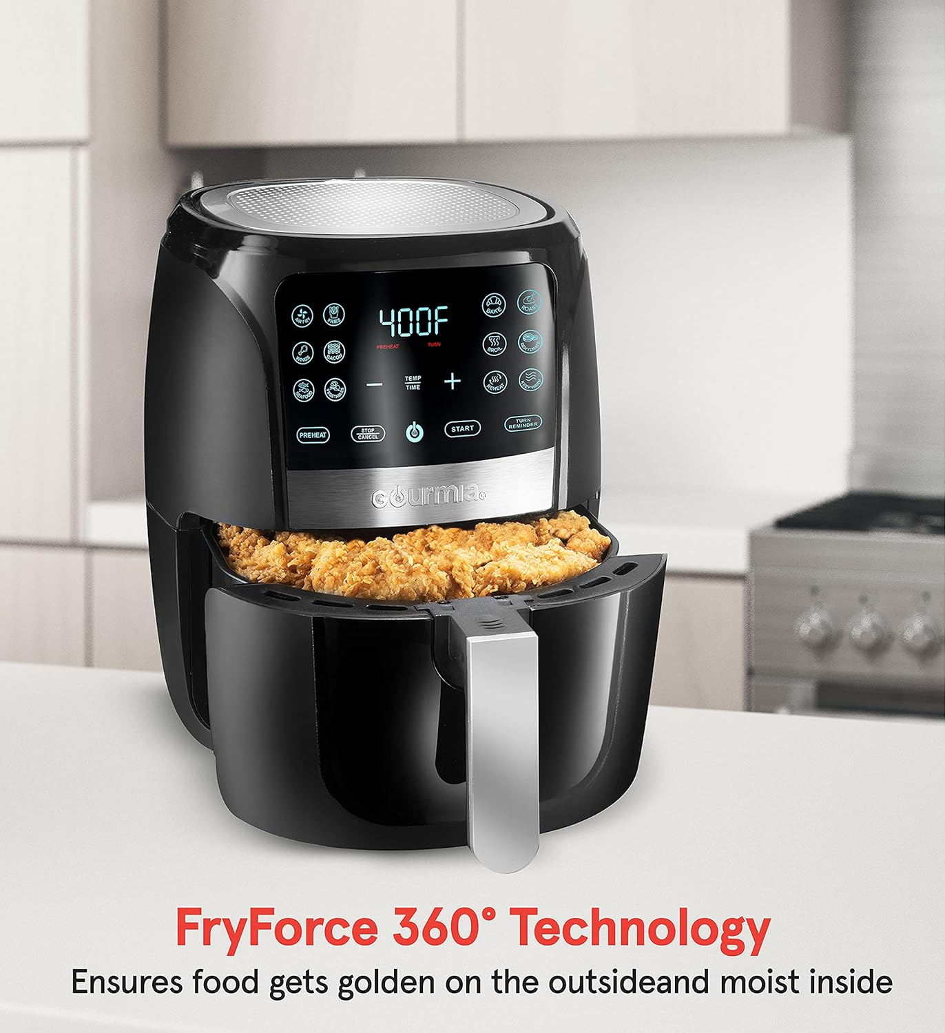 Black air fryer with food inside on a kitchen counter, featuring 'FryForce 360° Technology' text.