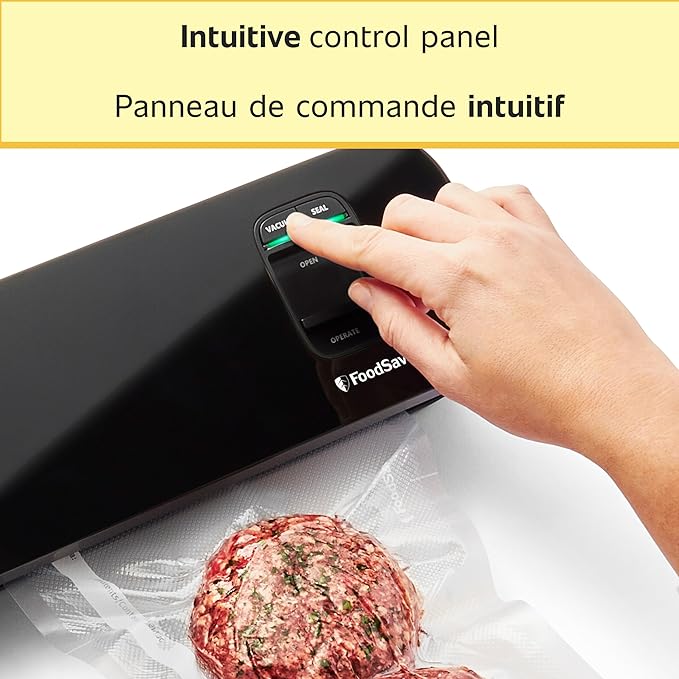 Hand operating an intuitive control panel on a FoodSaver device with a vacuum-sealed meat patty in the foreground.