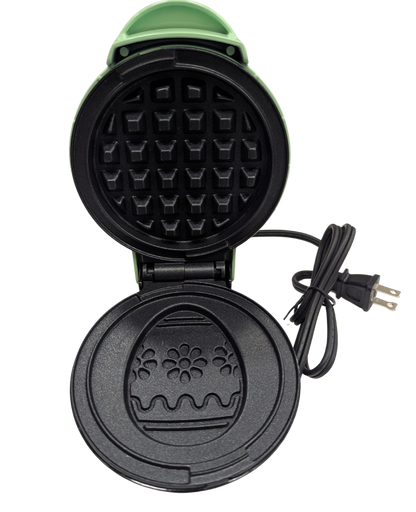 Black waffle maker with a floral design on a white background