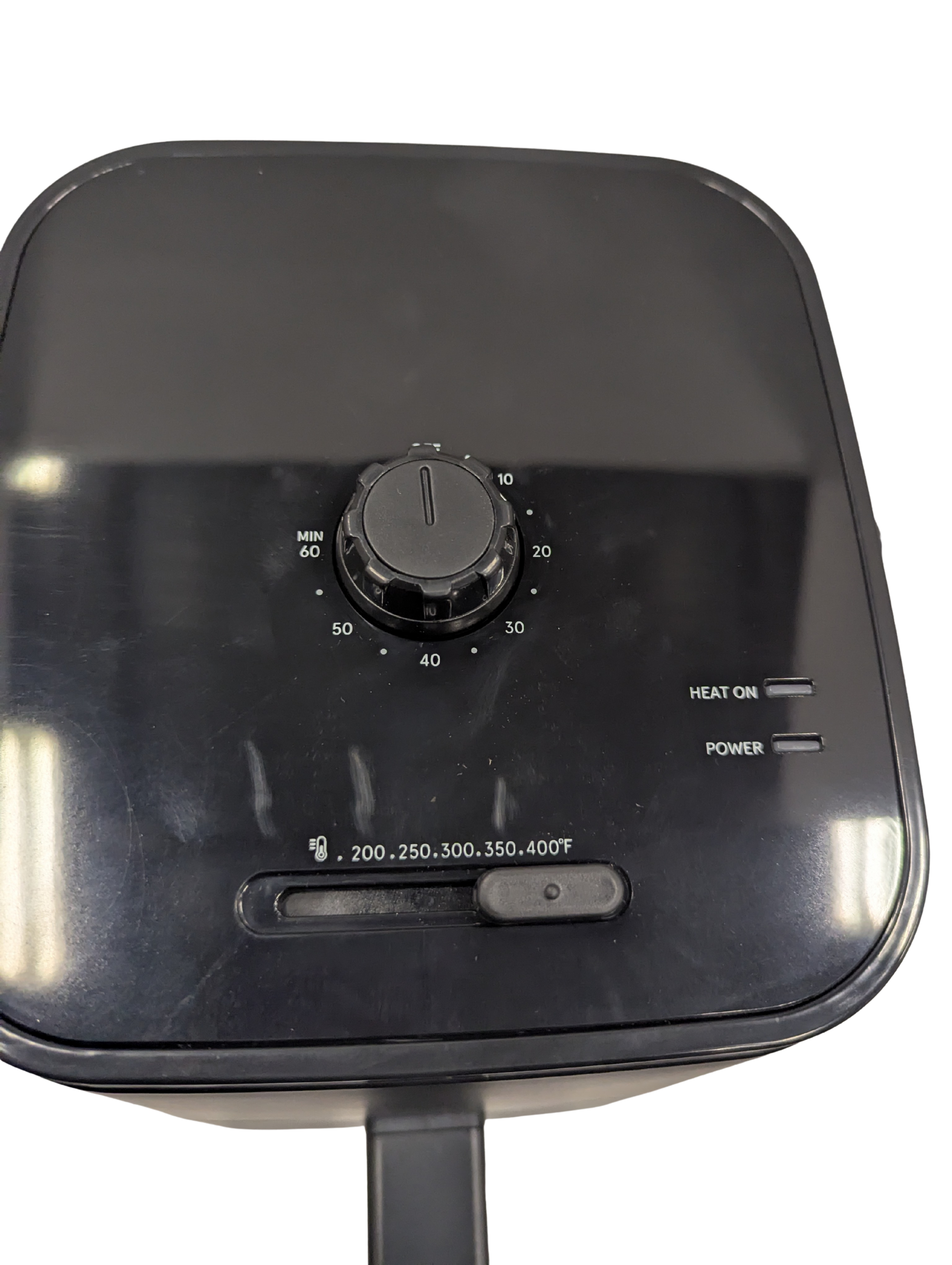 Black industrial heating element with control knob and temperature display on a white background