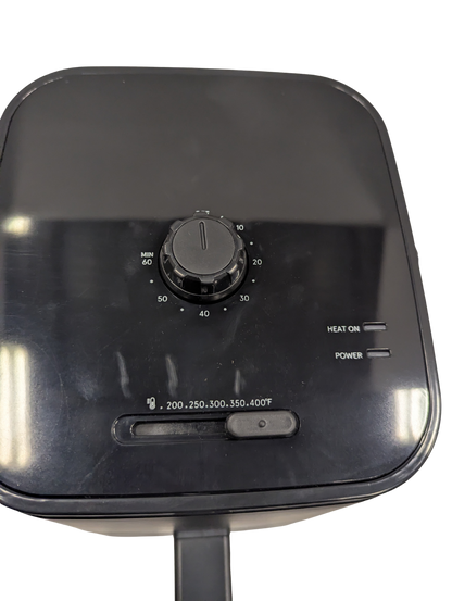 Black industrial heating element with control knob and temperature display on a white background