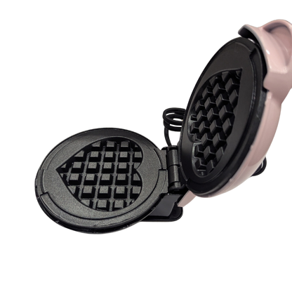 Waffle maker with heart-shaped waffle grid on a white background