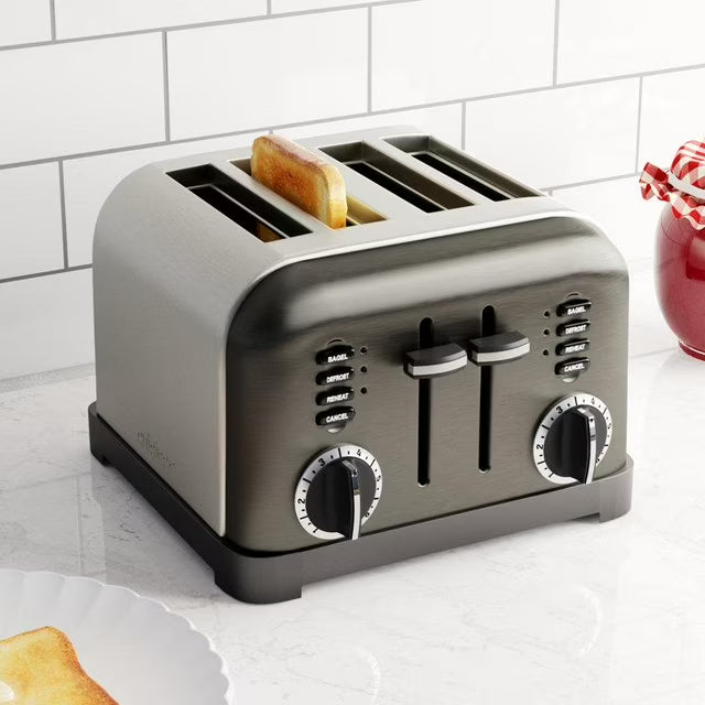 Gray toaster with slices of bread on a white countertop