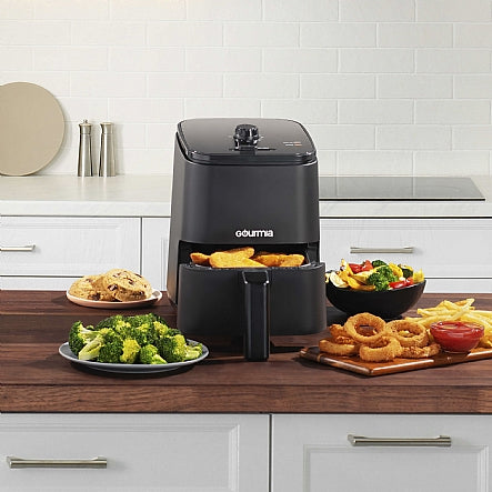 Gourmia air fryer on a kitchen counter with various fried foods.