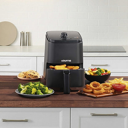Gourmia air fryer on a kitchen counter with various fried foods.