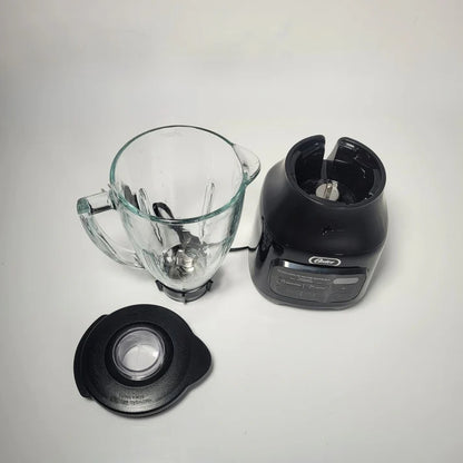 Blender components including a clear pitcher, black base, and lid on a light gray background