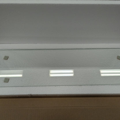 Glass panel with embedded lights in a cardboard box