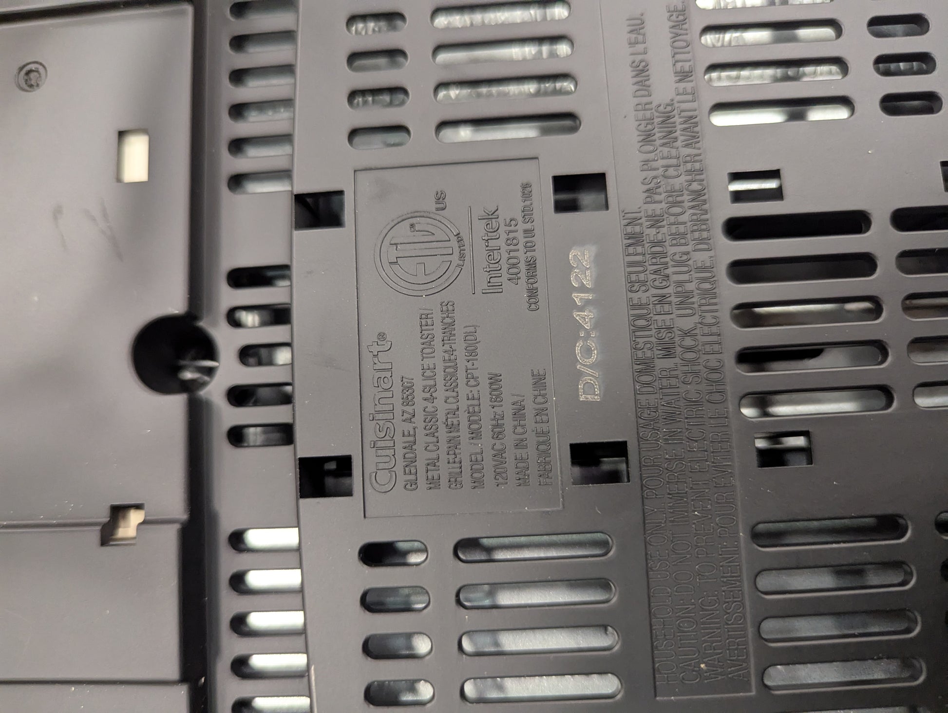 Close-up of a metallic surface with text and a logo, likely on electronic equipment.